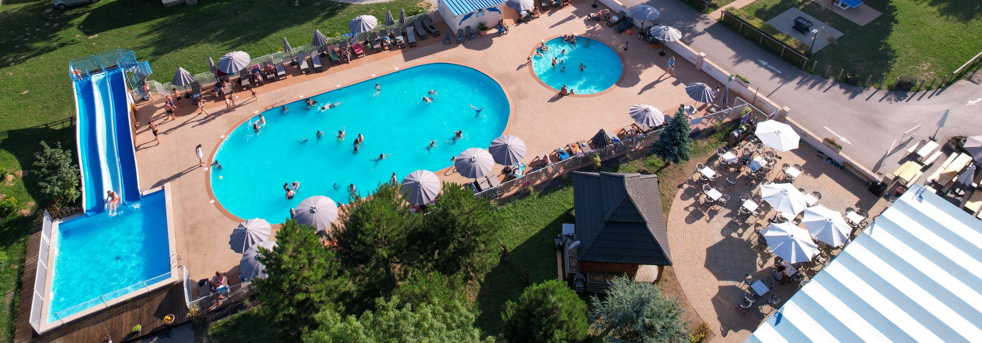 Aerial view of the water park at Les Bords de Loue campsite on the riverside