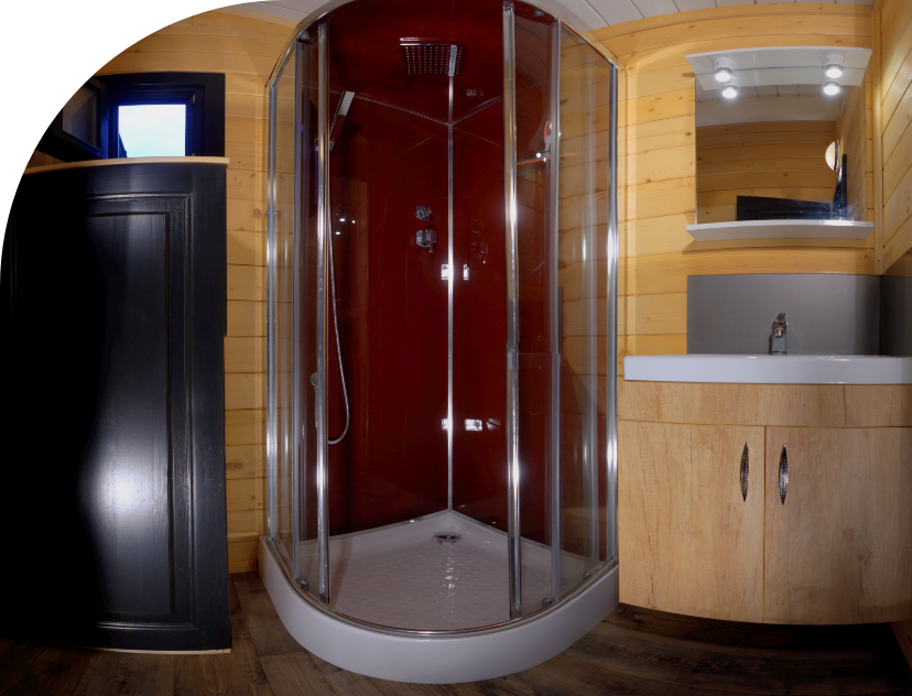 Bathroom with shower and wash basin in the Monia Chalet to rent at Les Bords de Loue campsite in Jura