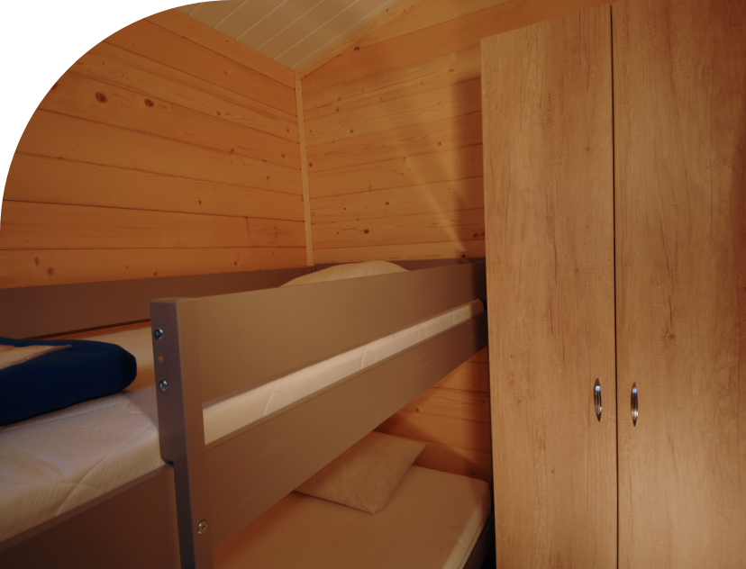 Bedroom with bunk beds in the Savania Chalet to rent at Les Bords campsite in the Bourgogne-Franche-Comté region