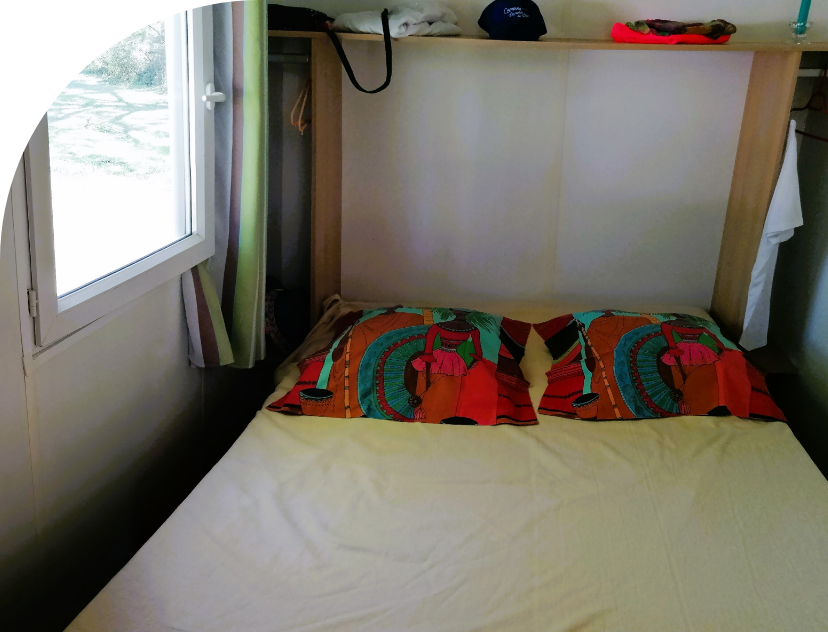 Bedroom with 1 double bed and storage space in the Tithome to rent at Les Bords de Loue campsite